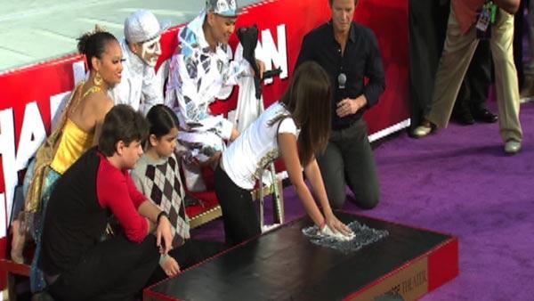 Paris Jackson places her late father Michael Jackson's sequined glove on plastic on top of cement and pushes down to create a handprint at the late King of Pop's hand and footprint ceremony at the Grauman's Chinese Theatre on Jan. 26, 2012.