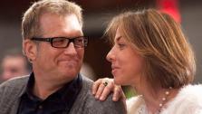 Comedian Drew Carey smiles as he looks at his finance Nicole Jaracz before announcing that he will be running in Sundays Marine Corp Marathon, his first marathon, Friday, Oct. 28, 2011, in Washington. - Provided courtesy of AP / Cliff Owen