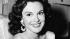 Film star Patricia Medina smiles in her room at...