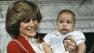 Prince William, the 6-month-old son of British Prince Charles, unseen, and Princess Diana, poses with his mother at a special photo call at Kensington Palace in London on Dec. 22, 1982.