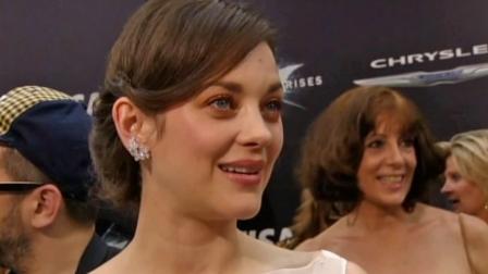 Marion Cotillard talks to reporters at the New York premiere of The Dark Knight Rises on July 16, 2012.