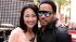 Lenny Kravitz and Ann Curry pose together on an...