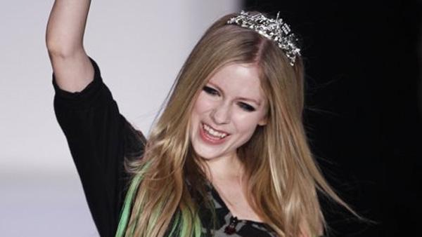 Avril Lavigne cheers as she walks down the runway of her own New York Fashion Week show, where she debuted her Abbey Dawn Spring/Summer 2012 collection, on Monday, Sept. 12, 2011.