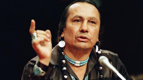 In a Jan. 31, 1989 file photo, Russell Means testifies before a special investigative committee of the Senate Select Committee on Capitol Hill, in Washington.