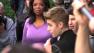 Oprah Winfrey watches on while Justin Bieber delivers a sidewalk performance for 'Oprah's Next Chapter' outside RL Restaurant in Chicago, Illinois on Wednesday, Oct. 24, 2012.