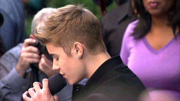 Oprah Winfrey watches on while Justin Bieber delivers a sidewalk performance for 'Oprah's Next Chapter' outside RL Restaurant in Chicago, Illinois on Wednesday, Oct. 24, 2012.