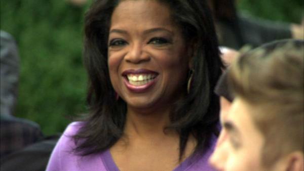 Oprah Winfrey watches on while Justin Bieber delivers a sidewalk performance for 'Oprah's Next Chapter' outside RL Restaurant in Chicago, Illinois on Wednesday, Oct. 24, 2012.