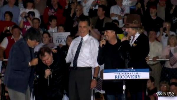 Republican presidential candidate and former Massachusetts Governor Mitt Romney sings 'America The Beautiful' with Meat Loaf as he campaigns at the football stadium at Defiance High School in Defiance, Ohio on Thursday, Oct. 25, 2012.