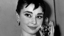 Oscar-winner Audrey Hepburn poses with her statuette at the 26th Annual Academy Awards ceremony in New York on March 25, 1954.