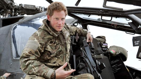 In this photo taken Dec. 12, 2012, made available Monday Jan. 21, 2013 of Britains Prince Harry or just plain Captain Wales as he is known in the British Army, talks to a TV crew. - Provided courtesy of AP Photo/ John Stillwell, Pool