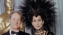 Don Ameche holds the Oscar he received for Best Actor in a Supporting Role, given for his performance in Cocoon, at the Oscars in Los Angeles on March 24, 1986. With him is presenter Cher.