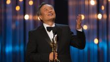 Ang Lee accepts his Oscar for Best Directing for Life of Pi at the 2013 Oscars in Los Angeles on Feb. 24, 2013.