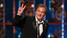 Quentin Tarantino accepts his Oscar for Best Writing (Original Screenplay) for Django Unchained at the 2013 Oscars in Los Angeles on Feb. 24, 2013.