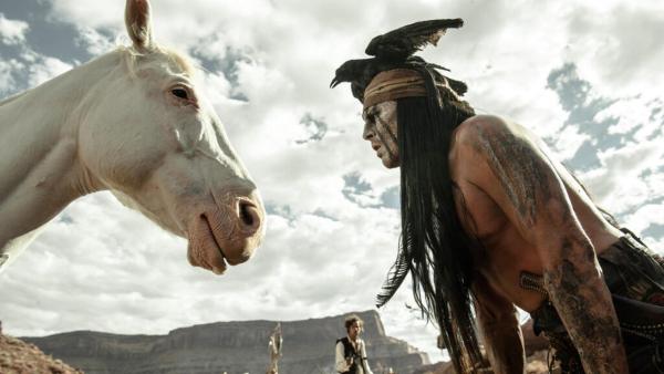 Johnny Depp challenges The Lone Rangers horse to a staring contest in a scene from Walt Disneys 2013 movie The Lone Ranger. - Provided courtesy of Walt Disney Pictures