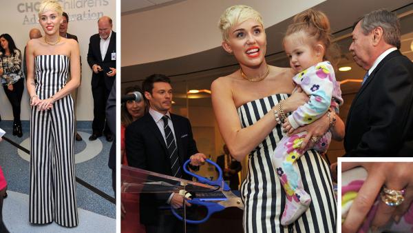 Miley Cyrus holds patient Janessa Martinez, 20 months old, of CHOC Childrens Hospital at the opening of the Ryan Seacrest Foundations multimedia broadcast center Seacrest Studios at the center on March 22, 2013 in Orange, California. - Provided courtesy of OTRC