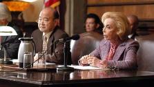 Dr. Joyce Brothers guest stars as Senator Diedre Kerner, (with guest star Clyde Kusatsu) who is on the Senate approval committee for the new JAG, on a 2004 episode of the CBS show JAG. - Provided courtesy of OTRC / Gale Adler / CBS / Paramount Television