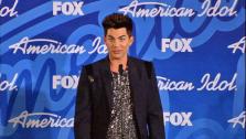 Former finalist and glam rocker Adam Lambert talks to reporters backstage after the American Idol season 12 finale on May 16, 2013. Candice Glover beat Kree Harrison to win the title. - Provided courtesy of none / FOX