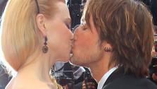 Nicole Kidman and Keith Urban kiss on the red carpet at the Cannes Film Festival on May 19, 2013. Kidman, dressed in a leaf-printed LWren Scott gown, is a member of the festivals jury. She and Urban attended a screening of Inside Llewyn Davis. - Provided courtesy of Joel Ryan / Invision / AP