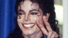 Michael Jackson visits his old Los Angeles school, Gardner Street Elementary School, and flashes the victory sign on Wednesday, Oct. 11, 1989. - Provided courtesy of AP Photo / Nick Ut