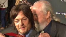The Walking Deads Norman Reedus (Daryl Dixon) hugs Scott Wilson (Hershel Greene) at the season 4 premiere in Los Angeles on Oct. 3, 2013. A beloved character was killed off in the midseason finale, which aired on Dec. 1, 2013. - Provided courtesy of OTRC