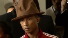 Pharrell, wearing a Vivienne Westwood hat, walks the red carpet at the 2014 Grammys on Jan. 26, 2014.