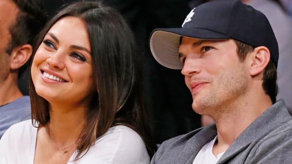 Actress Mila Kunis, left, and actor Ashton Kutcher, right, sit courtside together at the NBA basketball game between the Phoenix Suns and Los Angeles Lakers on Tuesday, February 12, 2013, in Los Angeles. - Provided courtesy of AP Photo / Danny Moloshok