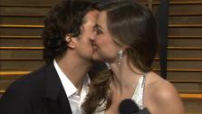 Orlando Bloom kisses estranged wife Mirana Kerr during her interview with OTRC.com at the Vanity Fair Oscars after party on March 2, 2014. - Provided courtesy of OTRC