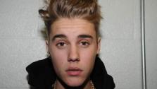 Justin Bieber appears at the Miami Beach Police Department following his January 2014 arrest. He was photographed to showcase his multiple tattoos. - Provided courtesy of Miami Beach Police Department
