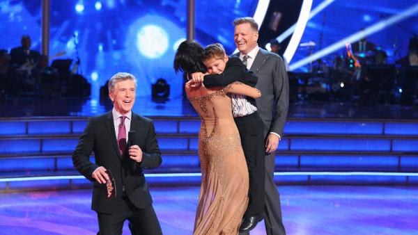 Drew Carey watches as partner Cheryl Burke hugs his son, Connor, after it is announced the two are safe from elimination on week 3 of ABCs Dancing With The Stars on March 31, 2014. - Provided courtesy of ABC Photo / Adam Taylor
