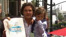 Orlando Bloom holds his and Miranda Kerrs son Flynn at his star ceremony on the Hollywood Walk of Fame. (April 2, 2014)