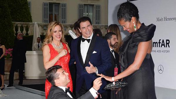 John Travolta and wife Kelly Preston watch producer Oscar Generale propose to his girlfriend, actress and model Denny Mendez, who accepted, at the amfARs 21st Cinema Against AIDS gala at the 67th Cannes Film Festival in France on May 22, 2014. - Provided courtesy of Lionel Hahn / Abaca / Startraksphoto.com John Travolta and wife Kelly Preston watch producer Oscar Generale propose to his girlfriend, actress and model Denny Mendez, who accepted, at the amfARs 21st Cinema Against AIDS gala at the 67th Cannes Film Festival in France on May 22, 2014. - Provided courtesy of Lionel Hahn / Abaca / Startraksphoto.com
