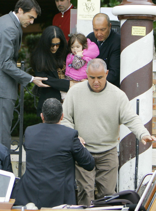 Salma Hayek, center, carries her daughter...
