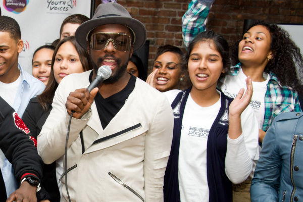 Black Eyed Peas member will.i.am sings with students at the launch of a new Peapod Adobe Youth Voices Academy in New York, Tuesday, April 19, 2011.