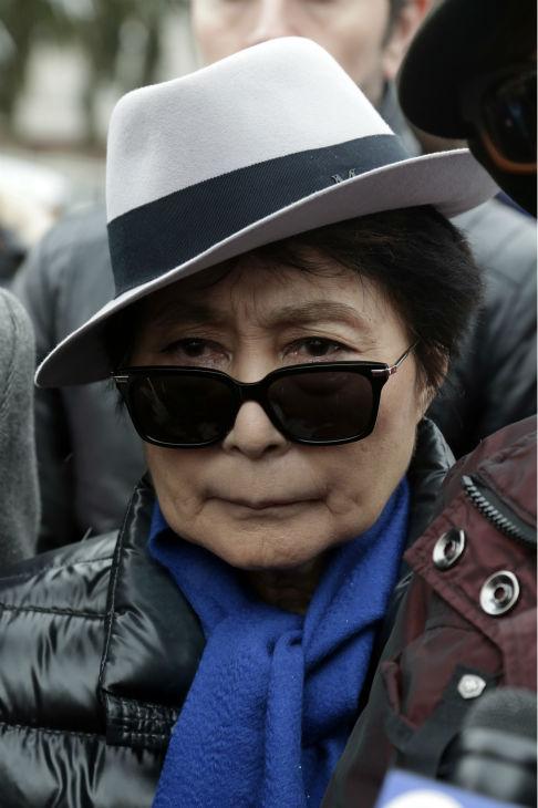 Yoko Ono appears at a news conference during a...