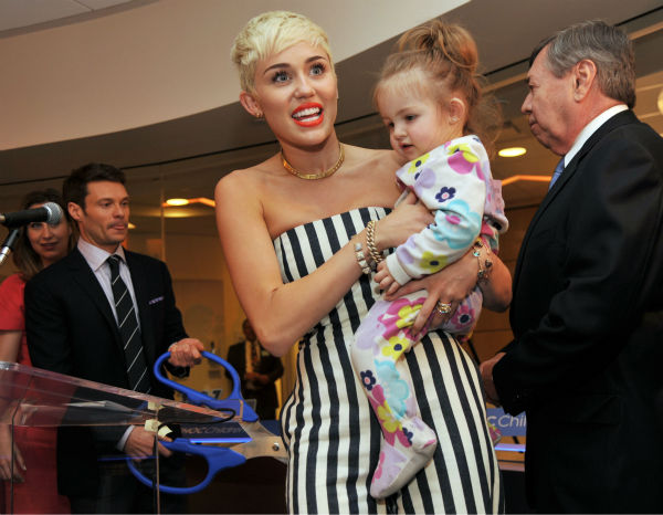 Miley Cyrus holds patient Janessa Martinez, 20...
