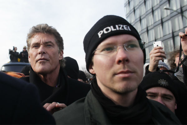 David Hasselhoff, left, is accompanied by police...