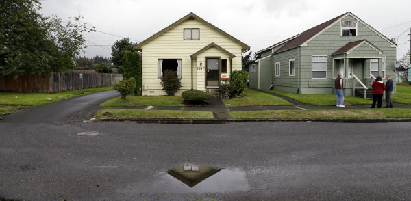 This  Sept. 23, 2013 photo shows the childhood home of Kurt Cobain, the late frontman of Nirvana, left, along an alley in Aberdeen, Washington.