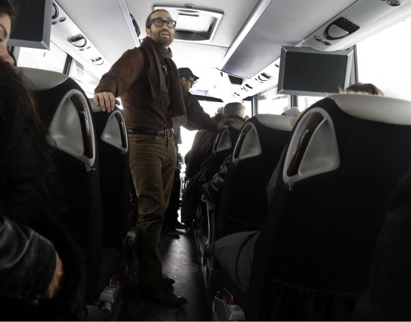 Sean Lennon looks out the windows aboard a bus...