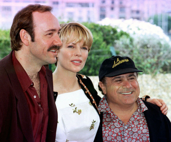 Kim Basinger poses between Kevin Spacey, left, and Danny De Vito during the presentation of 'L.A. Confidential,' in competition for the Cannes,France, Film Festival on May 14, 1997.