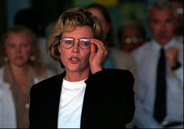 Kim Basinger adjusts her glasses as she reads a...