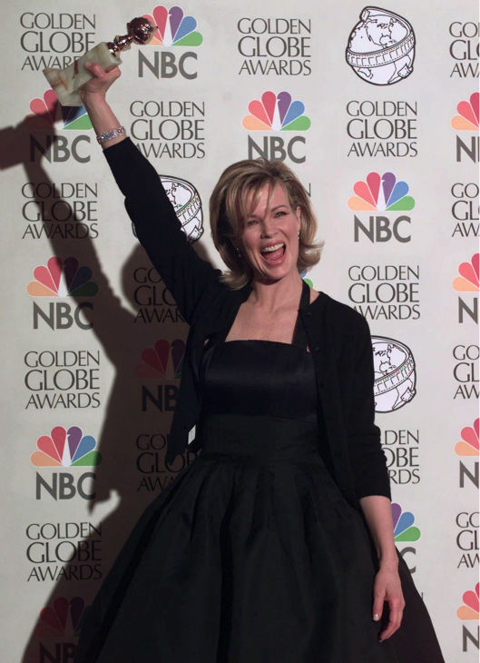 Kim Basinger raises her Best Supporting Actress...