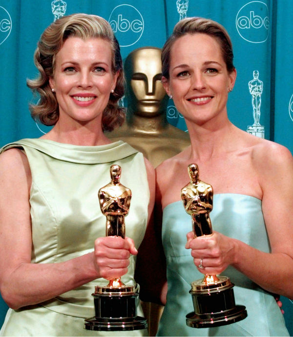 Kim Basinger, left, shows off her Oscar for Best...