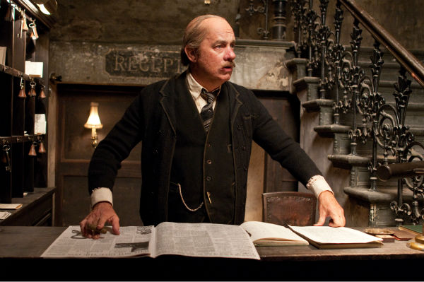 Tom Hanks appears as a hotel manager in a scene...