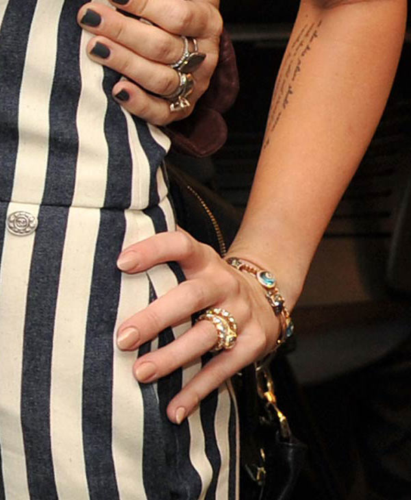 Miley Cyrus wears her engagement ring to the...
