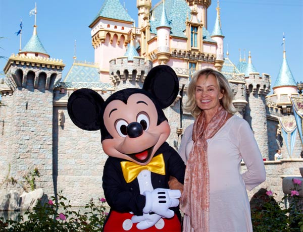 Jessica Lange poses with Mickey Mouse outside Sleeping Beauty Castle at Disneyland in Anaheim, California, on Sept. 2, 2011.
