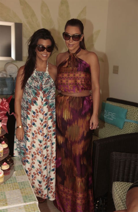 Kim Kardashian and her sister Kourtney appear at...
