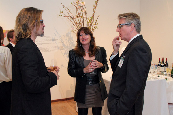Brad Pitt (left) appears near LACMA curator and...