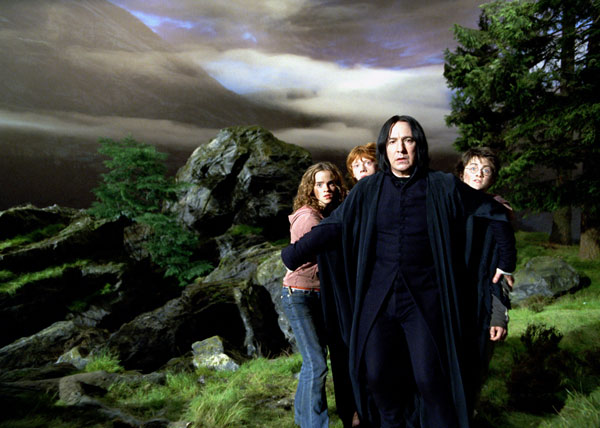 Hermione Granger (Emma Watson), Ron Weasley (Rupert Grint) and Harry Potter (Daniel Radcliffe) hide behind Professor Severus Snape (Alan Rickman) in a scene from the 2004 film 'Harry Potter and the Prisoner of Azkaban.'