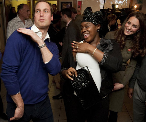 Prince William dances with Vanessa Boateng as his wife, Kate, the Duchess of Cambridge, looks on during their visit to Centrepoint's Camberwell Foyer in London on Dec. 21, 2011.