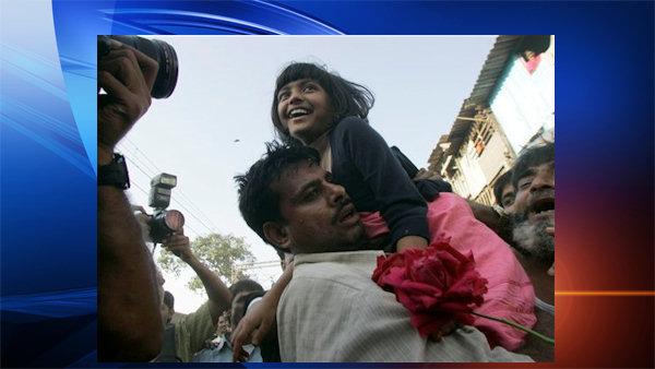 Slumdog Millionaire child actor Rubina Ali, 9, centre, reacts as she is welcomed back on her return to her home at a slum in Bandra, in suburban Mumbai, India, Thursday, Feb. 26, 2009. The child stars of the Oscar-winning Slumdog Millionaire returned to India on Thursday to a chaotic but rousing heroes welcome. (AP Photo/Rajanish Kakade)